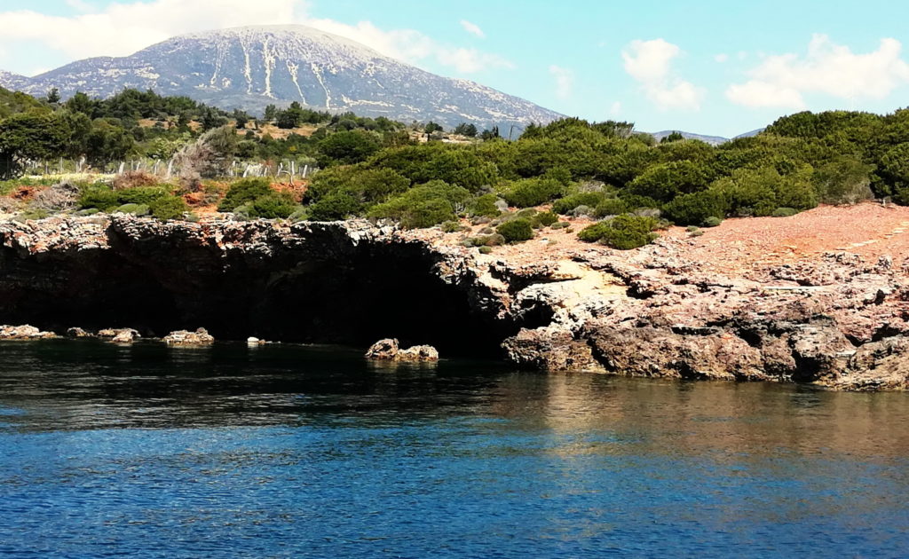 Trizonia has a varied landscape of olive trees, shrubs, and rocks