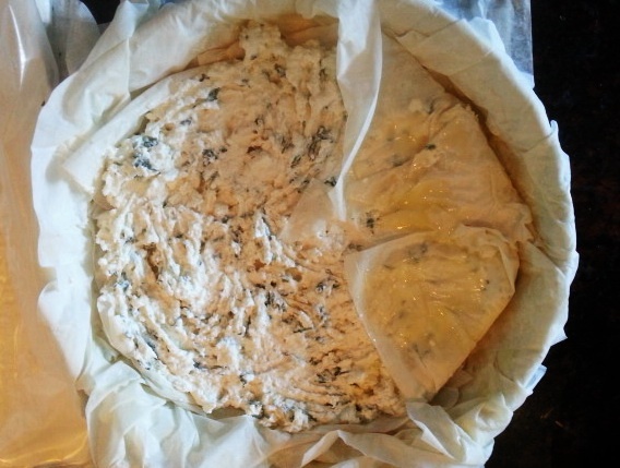 Tiropita - layering the phyllo over the filling for cheese pie