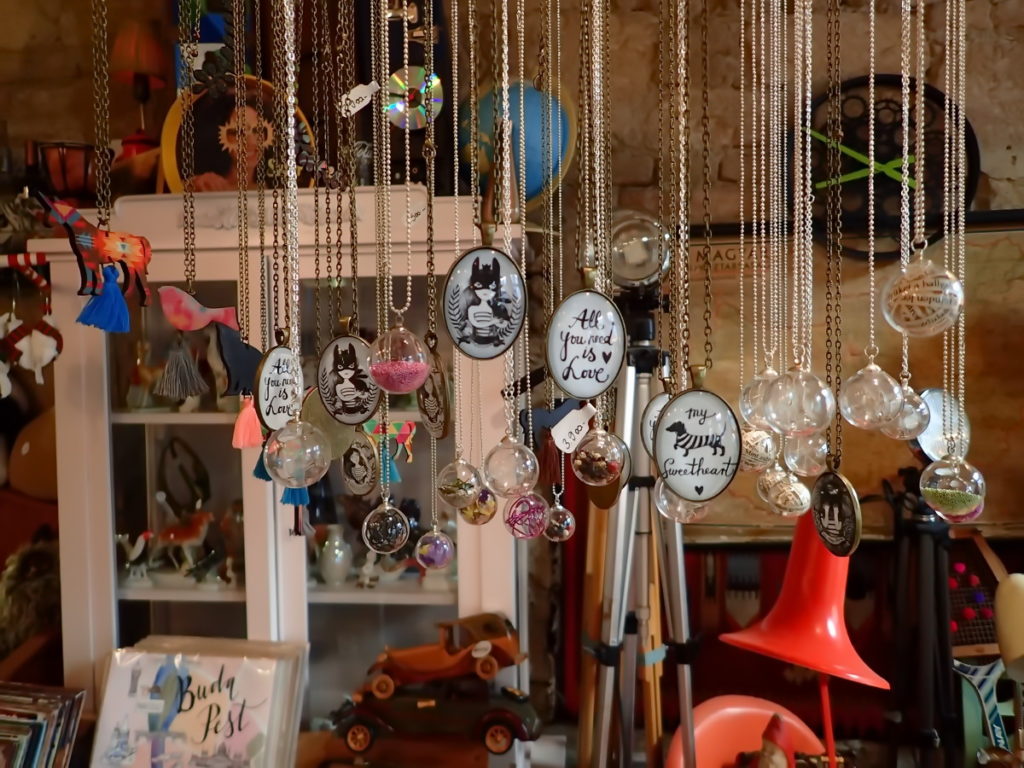 A row of necklaces and other deign objects at Szimpla Kert's shop