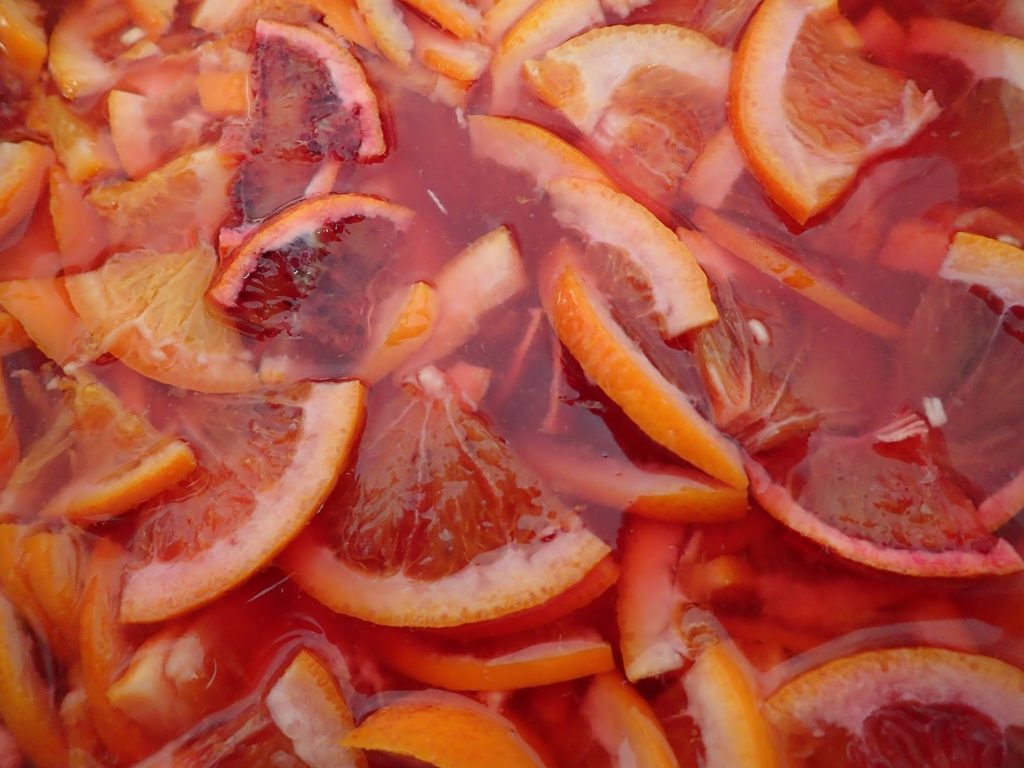 Thinly sliced blood oranges soften in cold water overnight to make blood orange marmalade with orange blossom water.