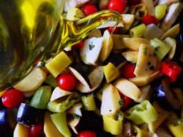 Briam - tourlou, vegetables and fresh herbs, drizzled with olive oil and ready for the oven