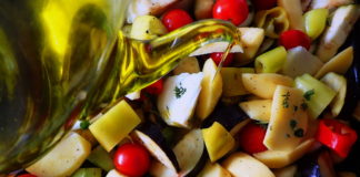 Briam - tourlou, vegetables and fresh herbs, drizzled with olive oil and ready for the oven