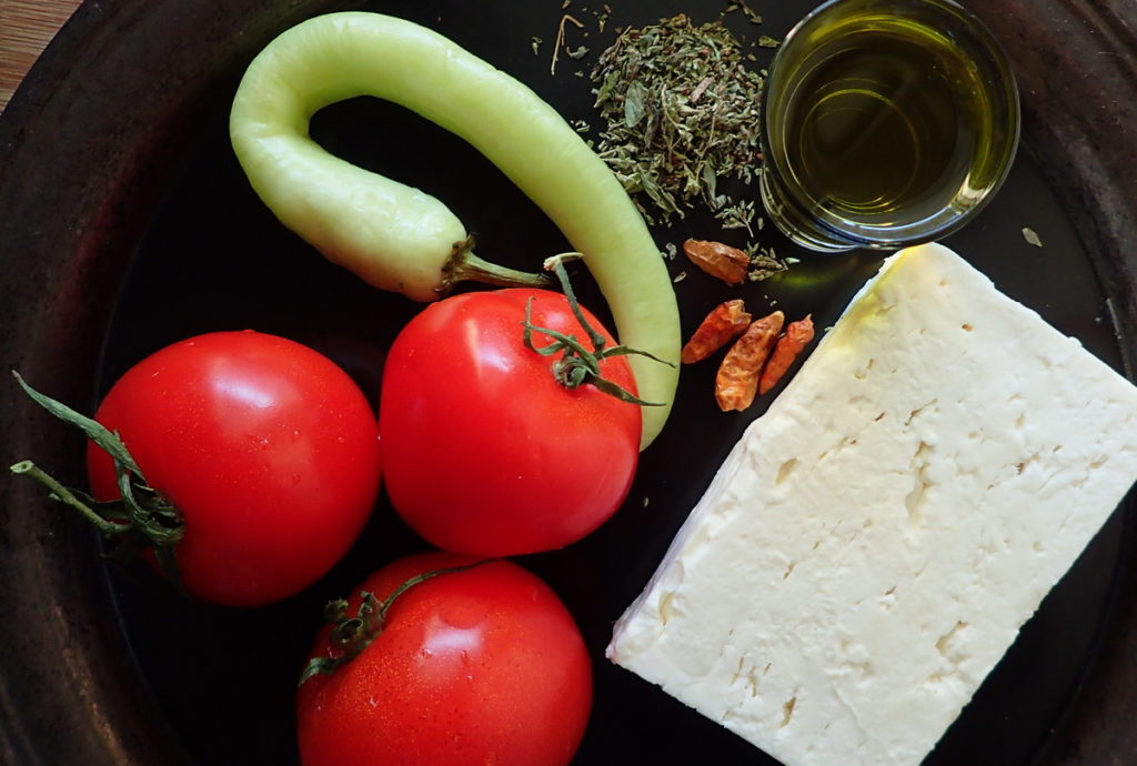 Bougiourdi ingredients - Feta and tomato, plus peppers - both Fresh and dried - for heat, and extra virgin olive oil and wild oregano to finish.