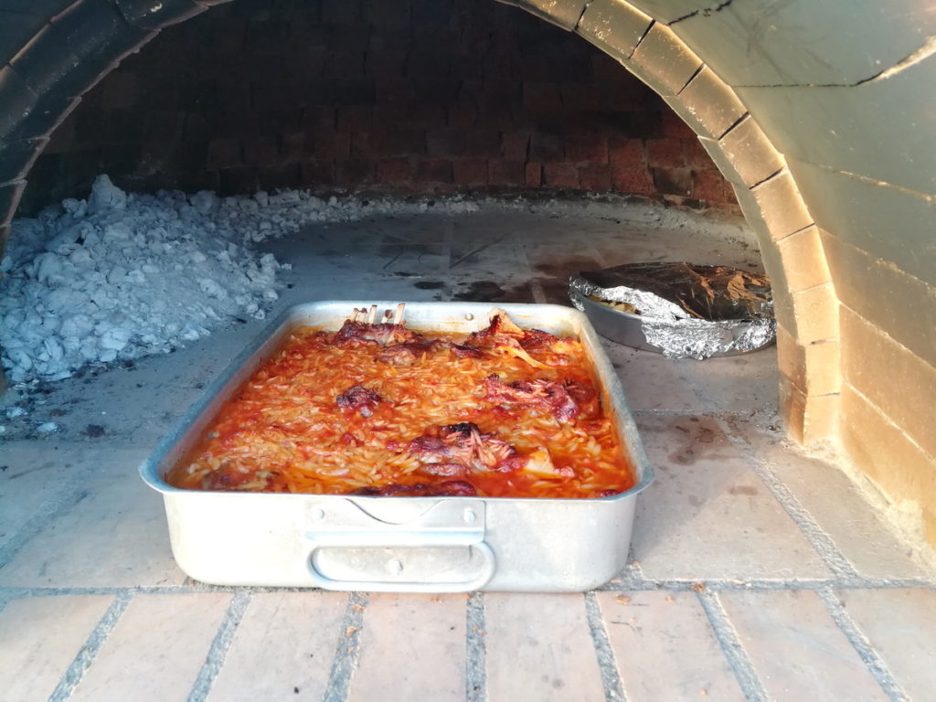 Goat with kritharaki from a wood-burning oven