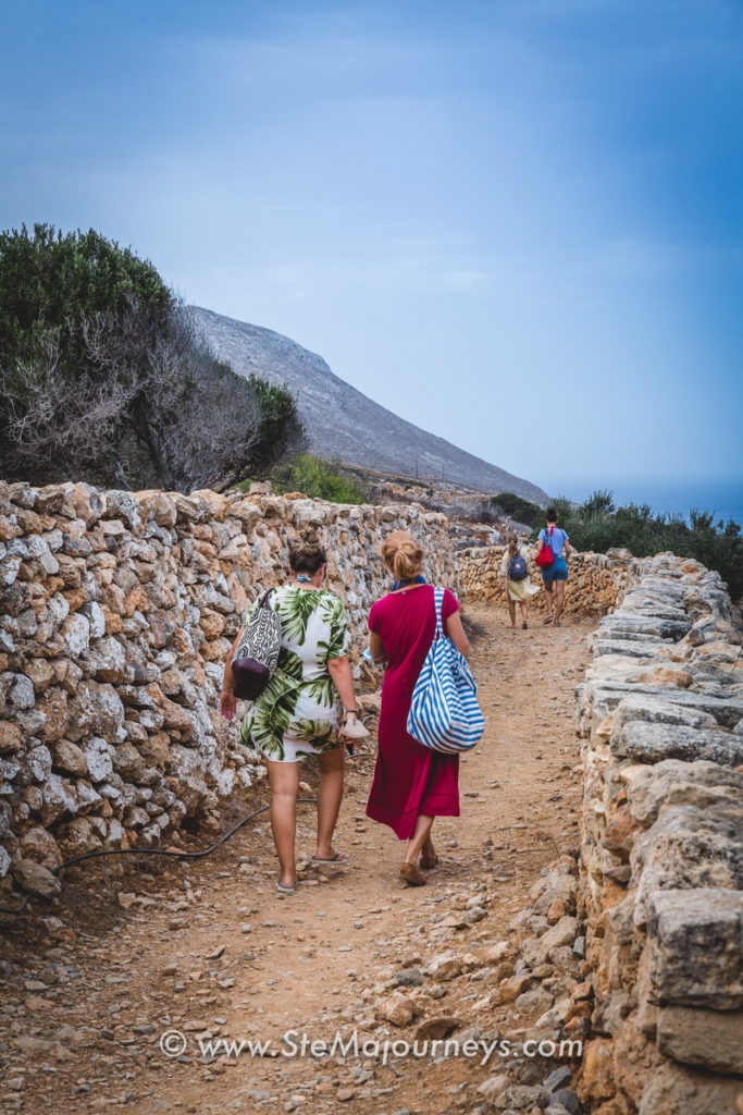 Elena of Passion for Greece and I, as we walk along a rocky path to the Mycenaean excavation.