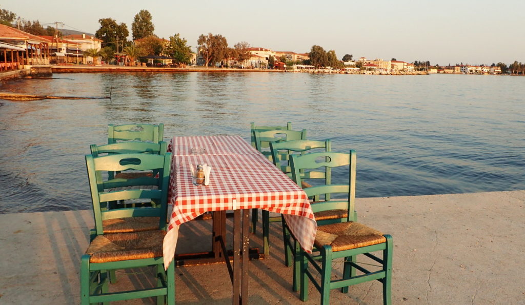 A quiet moment before the evening rush at a seaside tsipouradiko in Agria, Volos - Tsipouro: The Traditional Greek Spirit - Provocolate