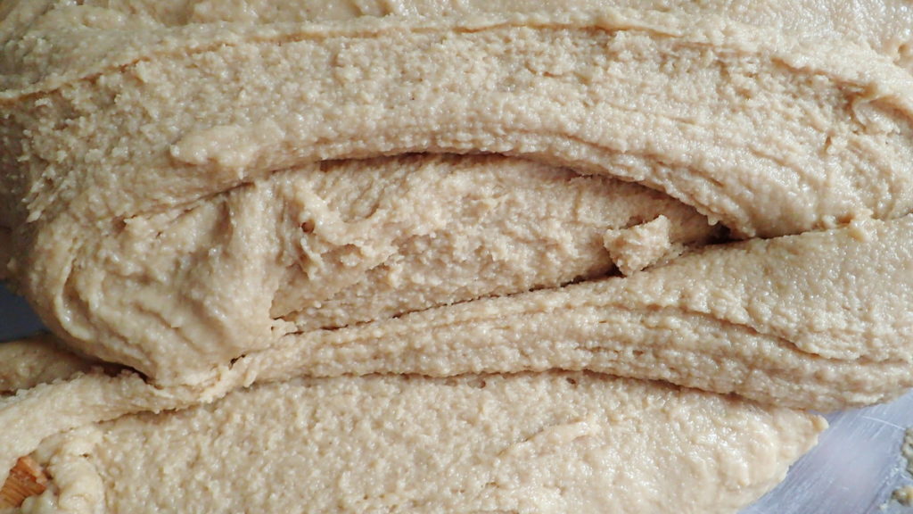 Spreading and folding the halva for a flaky texture