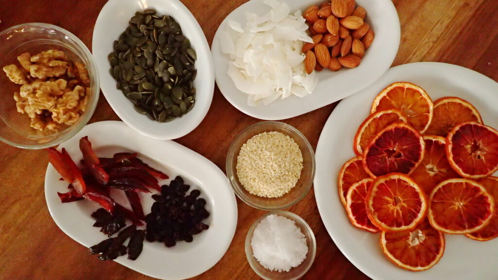 Ingredients for Topping Mendiants - almonds, pepitas, coconut, sea salt, dried orange slices, raisins, dried plums 