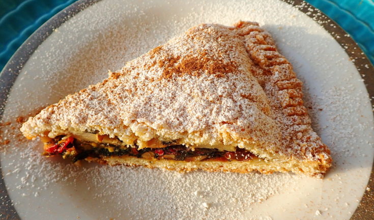A slice of tourte aux blettes with sugar and cinnamon