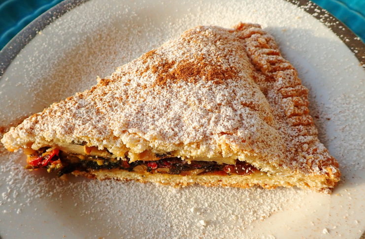 A slice of tourte aux blettes with sugar and cinnamon