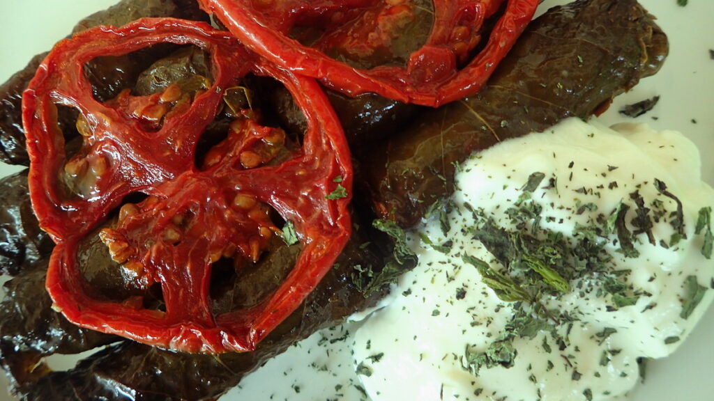 Dolmadakia - Greek vine leaves stuffed with rice and herbs, with yogurt on the side