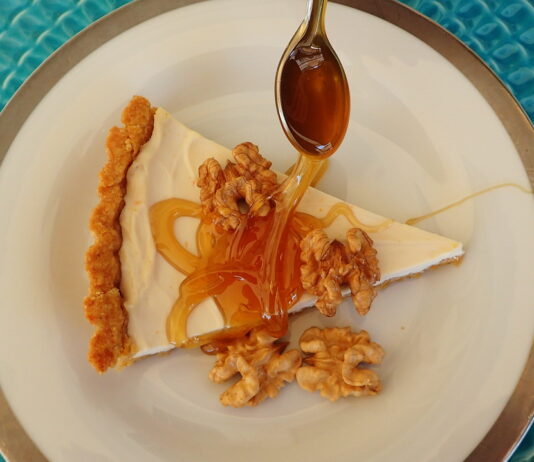 Honey Yogurt Tart sreved with a thick drozzle of honey and shelled walnuts