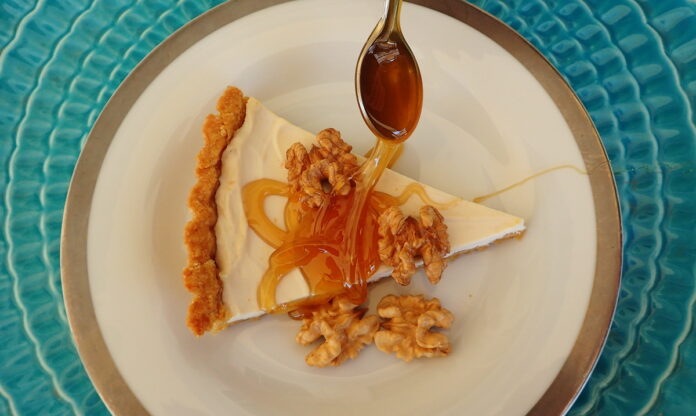 Honey Yogurt Tart sreved with a thick drozzle of honey and shelled walnuts