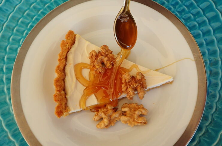 Honey Yogurt Tart sreved with a thick drozzle of honey and shelled walnuts